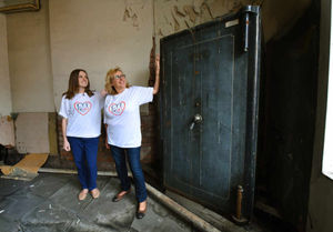 Assistant director, Holly Parry, and director, Jane Ward, of the Central Youth Theatre next to the huge Chubb safe