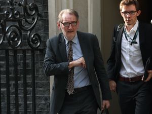 Sir Ian Diamond walks along a street