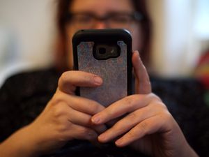A woman holding a mobile phone