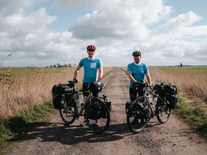 A father and son with bikes laden with kit