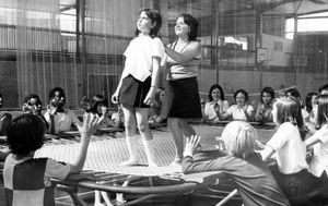 August 1975: 'Caroline Broome from Our Lady of Mercy Convent Grammar School, Wolverhampton, receiving instructions on the trampoline from Miss Moira Chadwick - one of the instructors at Compton,' reads the caption.