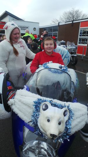 Josh hops aboard a festively decorated motorbike