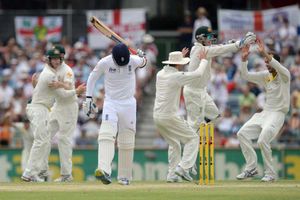 England's Graeme Swann (centre) reacts after losing his wicket to Australia's Nathan Lyon (right)