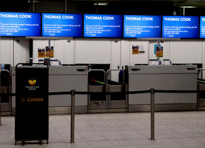 Empty Thomas Cook check-in desks at Gatwick Airport in Sussex as the 178-year-old tour operator has ceased trading with immediate effect