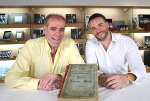James Price (right), fifth generation of the Price family to become CEO with his father Simon, who is now chairman, with the original minute book when the company was founded in 1902
