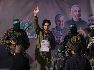 Israeli hostage waves while surrounded by militants