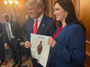 Deputy First Minister Emma Little-Pengelly presenting US President Donald Trump with a personalised flag from Royal Portrush Golf Club