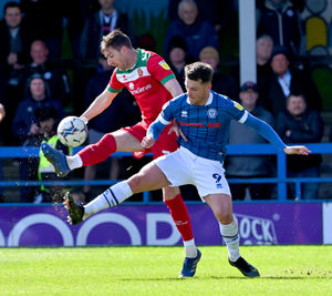 Stephen Ward looks to hook the ball away under pressure from Rochdale’s Luke Charman on Saturday afternoon