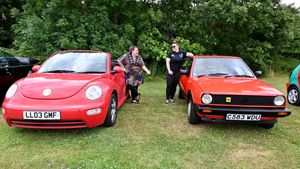 Dawn Major and Sophie Hughson pose with their past and present VWs