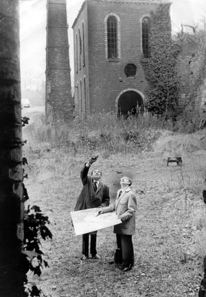 John Madin, planning consultant of Dawley Development Corporation, and his assistant Lewis Jones, surveying ruins at Blists Hill in December 1963.
