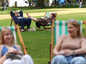 People enjoy the warm weather in St James’s Park, London