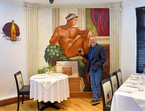 Geoff Tristram, who has hand painted a huge replica of the hands from Michelangelo's The Creation of Adam on the wall of Il Michelangelo restaurant