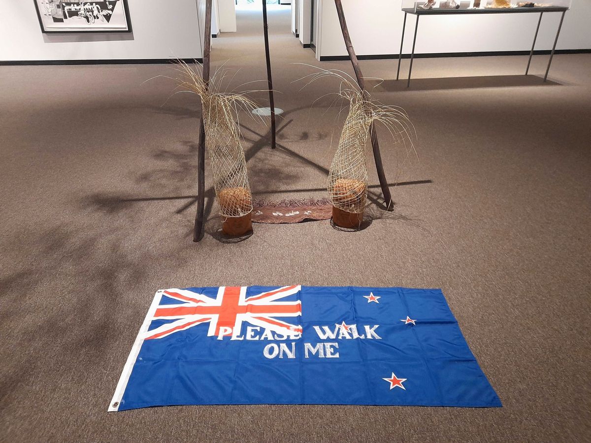 Protests over ‘please walk on me’ flag artwork prompt its removal from gallery