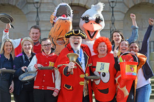 The return of the annual Pancake Race, Stafford town crier Peter Taunton with competitors
