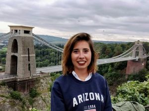 Handout photo of Marta Elena Vento smiling in front of a bridge