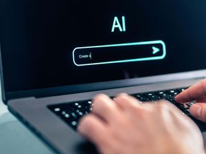Hands using computer with artificial intelligence app