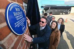 Prospect Coaches in Lye where a plaque was unveiled commemorating the late Ros Hadley. L-R: Ros's son Nathan Hadley, Laura Hadzik (national chair of Women in Bus and Coach), Karen Tiley (Midlands chair of Women in Bus and Coach), Nathan's wife Claire Hadley-King and the couple's sons Tom King and Jake Hadley, with the West Bromwich Albion first team coach to the rear