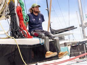 Triple amputee veteran sat on a sail boat