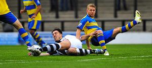 Matt Regan slides in to make a strong challenge