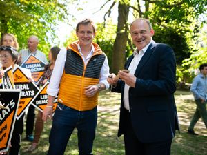 Sir Ed Davey signs spatulas with MP Mike Martin