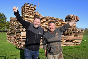 Organiser Mark Mitchell and bonfire builder Jordan Adams next to the mountain of pallets in Donnington