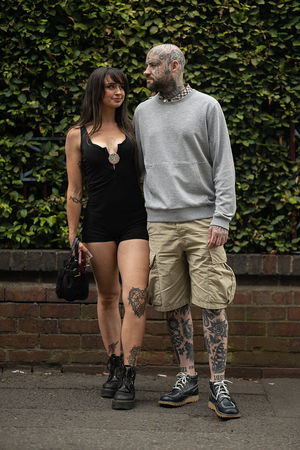 Music fans Charlotte Walker (L) and Stuart Purcell (R) arrive to attend British rock band Black Sabbath's "Back to The Beginning" concert, Ozzy Osbourne's final ever gig as Black Sabbath's frontman at Villa Park in Birmingham, central England on July 5, 2025. Osbourne, who revealed in 2020 that he has Parkinson's disease, will join Tony Iommi, Geezer Butler and Bill Ward for the all-day "Back To The Beginning" show in Birmingham, central England, where the heavy metal giants formed in 1968. (Photo by Oli SCARFF / AFP) (Photo by OLI SCARFF/AFP via Getty Images)          