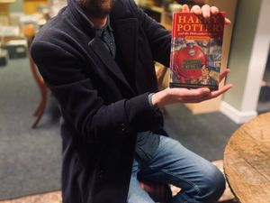 Jim Spencer, director of Rare Book Auctions, with Katie's pristine hardback first edition of Harry Potter and the Philosopher's stone. Photo: Rare Book Auctions