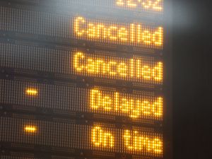 A train departures board showing cancelled and delayed services