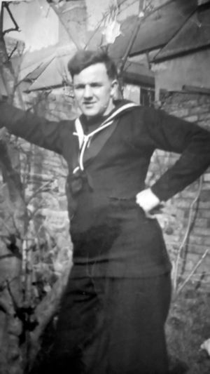 In his naval uniform.