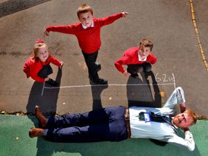 Supporting image for story: Headteacher gets measured in pupil's feet to celebrate World Maths Day