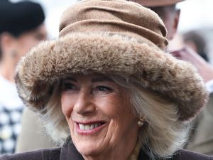 Close-up of the Queen wearing a fur-trimmed brown hat