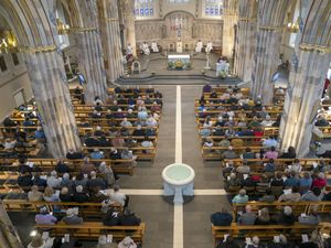 Overhead view of worshippers at a mass service following the death of Pope Francis