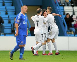 Sean Clancy of AFC Telford United celebrates with Neill Byrne and Robbie Booth after scoring a goal to make it 2-0