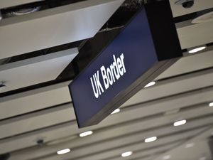 A passport control sign at Manchester Airport