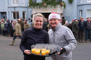 The Burton Hotel owner Jana Hyde with former owner John Richardson serving drinks to the hunt members. Image by Andy Compton