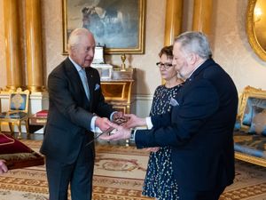 The King bestows a new ceremonial sword to the Usher of the Black Rod of the Senate of Canada Gregory Peters with Speaker of the Senate of Canada Raymonde Gagne