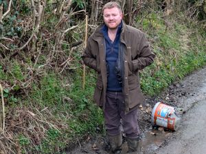 Bryn Robinson shows how deep one pothole is in Church Preen. Picture: LDRS
