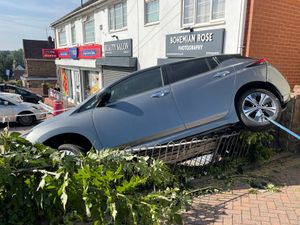 Supporting image for story: Electric car left wedged on wall as manoeuvre goes wrong in the Black Country