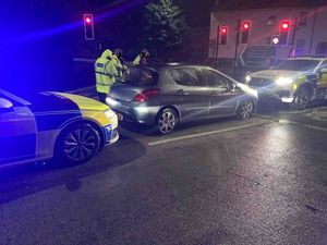 Photo shows the Peugeot boxed in by two police cars