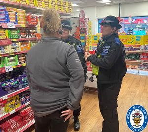 Officers talk to shop staff in Bearwood as part of Operation Peppermint