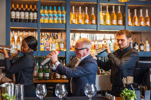 Students Tamara Pinnock (left) and Shane Masters (right), showing the Mayor Richard Parker (centre), the art of cocktail making at All Bar One. PIC: West Midlands Combined Authority