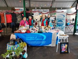Volunteers at Penkridge Market, joined by a nameless bear, enjoy a successful day