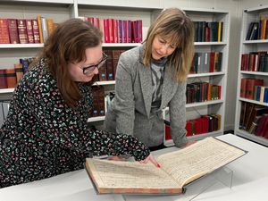 Councillor Hayley Coles reviewing the history centre's physical records, as well. 