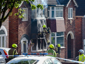 Supporting image for story: Manhunt begins as house set on fire with woman and children inside