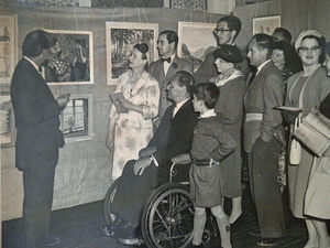 An earlier art club exhibition being admired by visitors