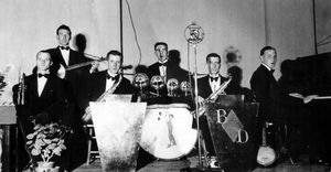 The Blue Diamond Dance Band pictured in the 1930s or 1940s. Picture shared by Peter and Heather Speake. Mr Speake says they were very much in demand to play at dances in Builth Wells and Llandrindod Wells and surrounding villages. Identifies them as: (his father) leader, Reginald Speake, carpenter and builder, of Hospital Road, Builth Wells, third from left on 1st saxophone. Others, from left, 'Toffee' Evans, of Llandrindod Wells, on trumpet; Cliff Phillips, car mechanic, of Builth Wells on guitar (or banjo); Evan John Evans, of Builth Wells, on drums; Kenny Davies, painter and decorator, of Builth Wells, on 2nd saxophone; and Ellis Jones, dentist's son, on piano.