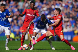               Everton's Ashley Young battles for the ball