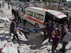 Palestinians help an injured man