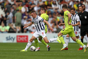 Jed Wallace battles with Duane Holmes (Photo by Adam Fradgley/West Bromwich Albion FC via Getty Images).