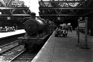 A steam train at Shrewsbury in 1957. The roof was taken down in 1963.